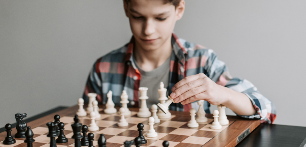 Young chess player thinking - A child focusing on a competitive chess match during an advanced coaching session